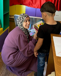 Woman and child looking at a coloured book