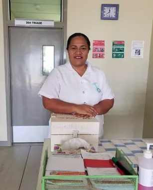 a nurse standing behind a table